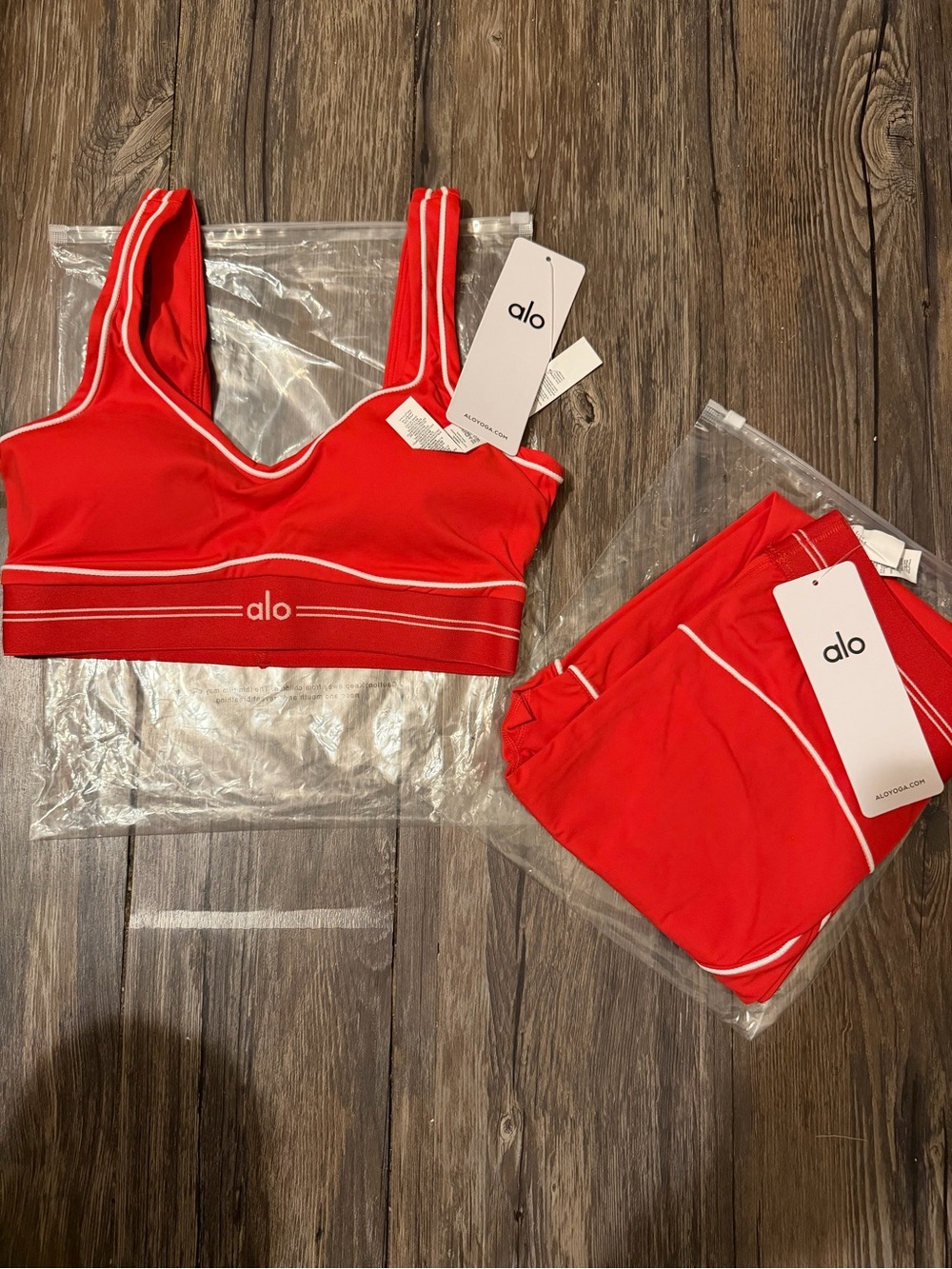 ALO Yoga red sports bra with white piping